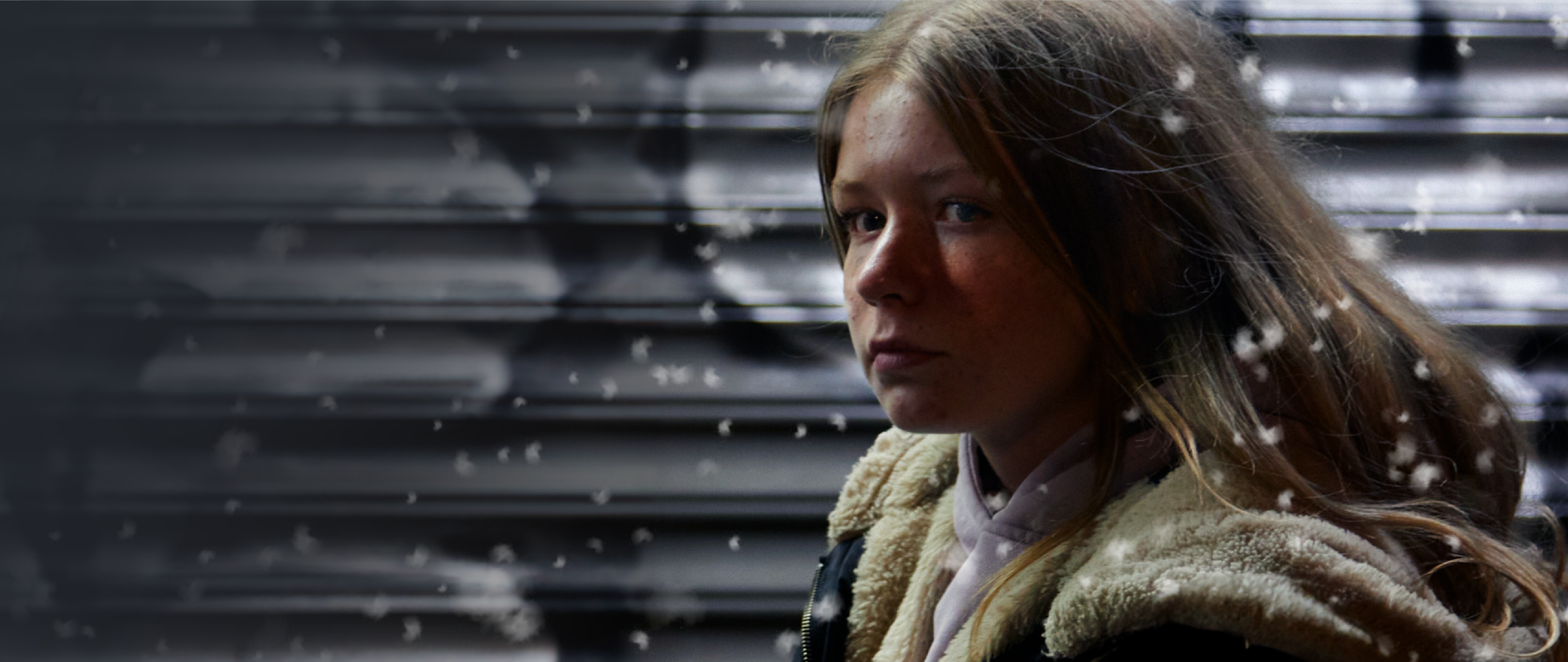young girl in a coat outside alone in the cold